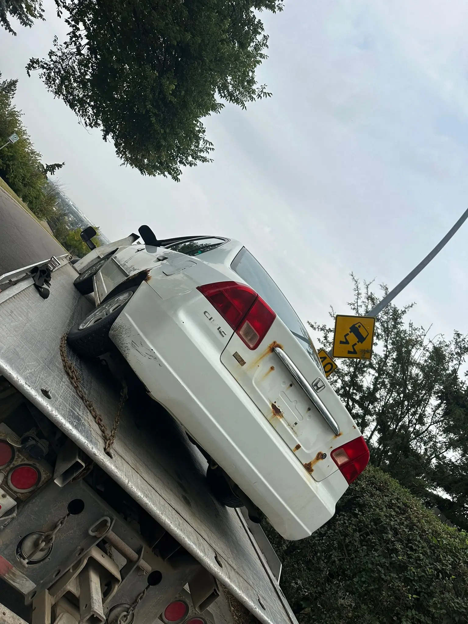 Rusted Honda on flatbed